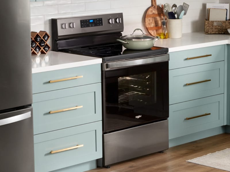 A pot sits on top of a Whirlpool® Oven