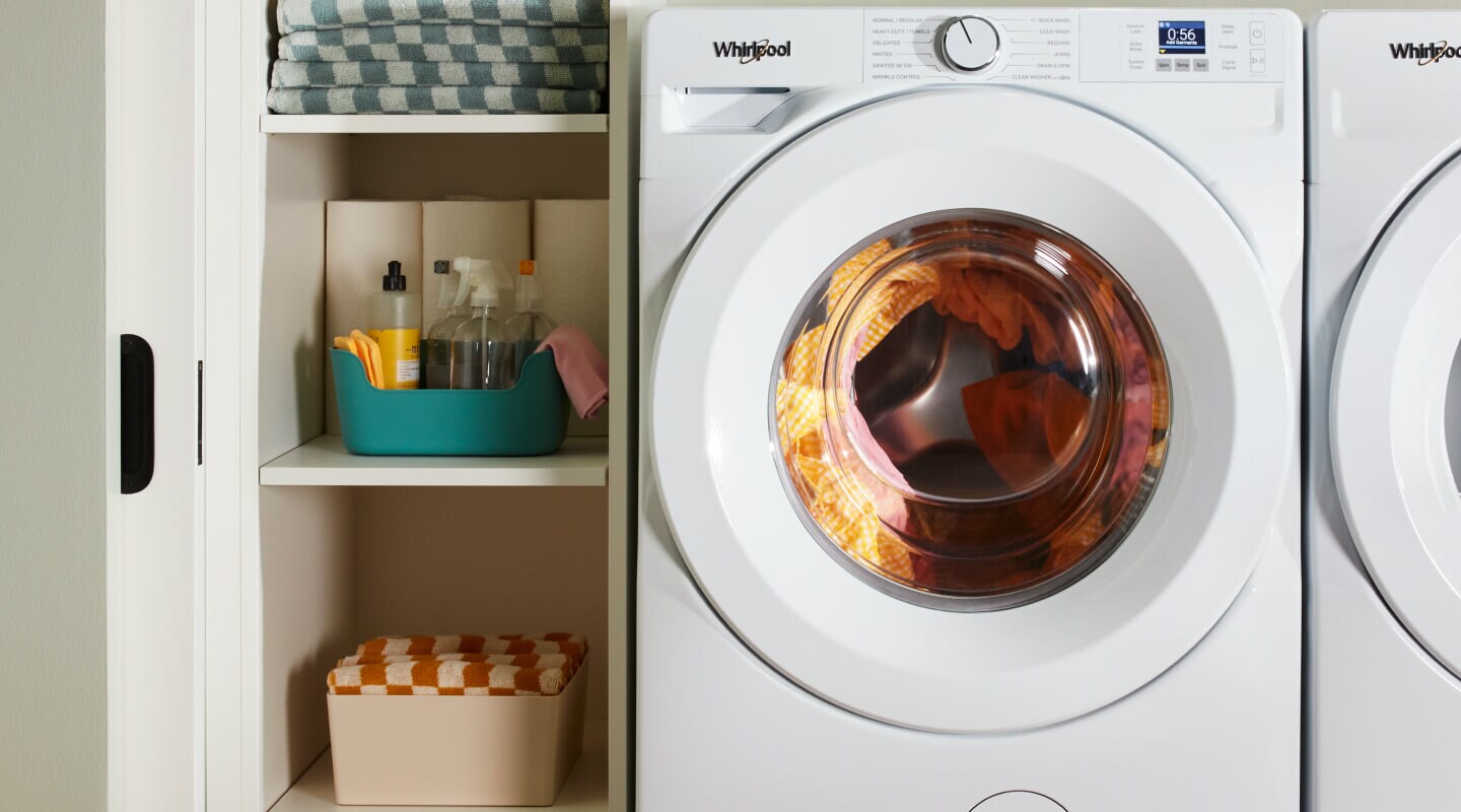 White Whirlpool® Front Load Washer filled with laundry