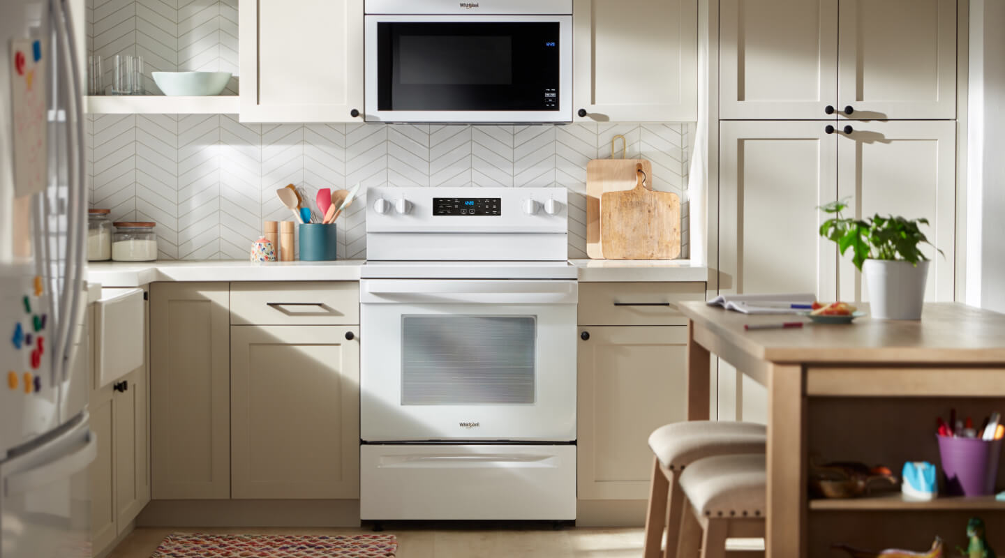 White Whirlpool® range in beige cabinetry