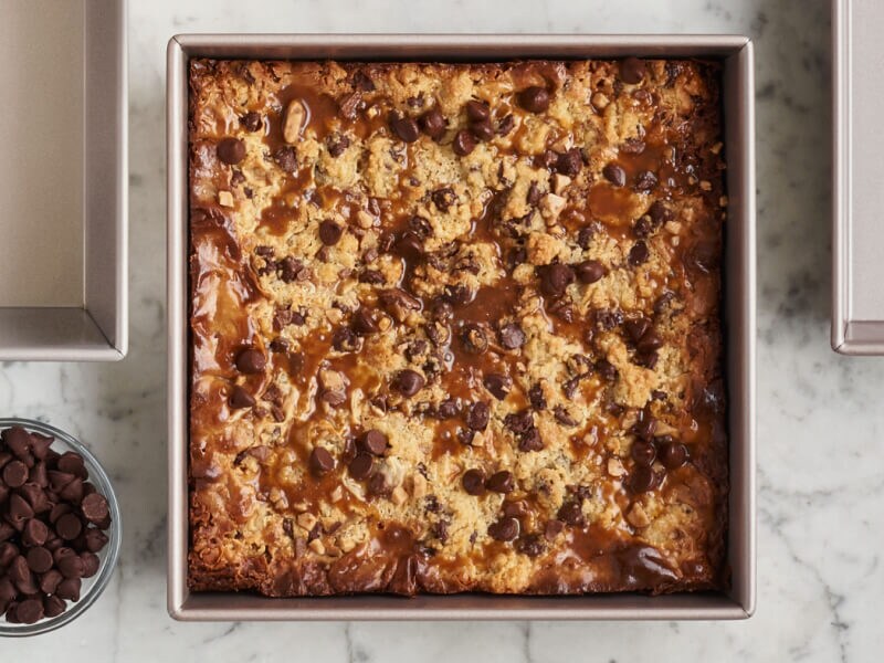A square pan with a baked blondie brownie recipe on the inside A square pan with a baked blondie brownie recipe on the inside