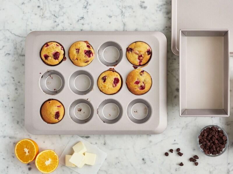 A muffin tin with cranberry muffins in 6 of the 12 cups A muffin tin with cranberry muffins in 6 of the 12 cups