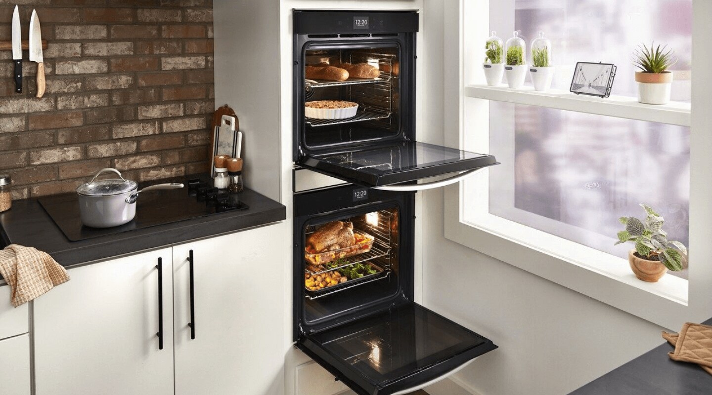 Double wall ovens with doors open displaying various dishes