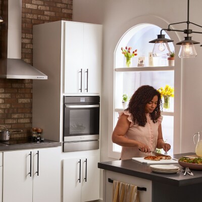 A cook slicing through a finished meal