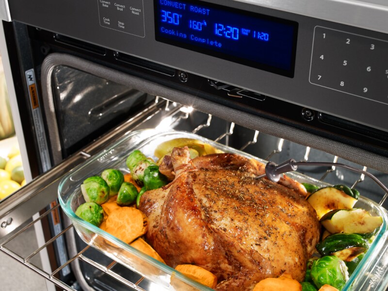 A meat probe pressed into a roasted chicken A meat probe pressed into a roasted chicken