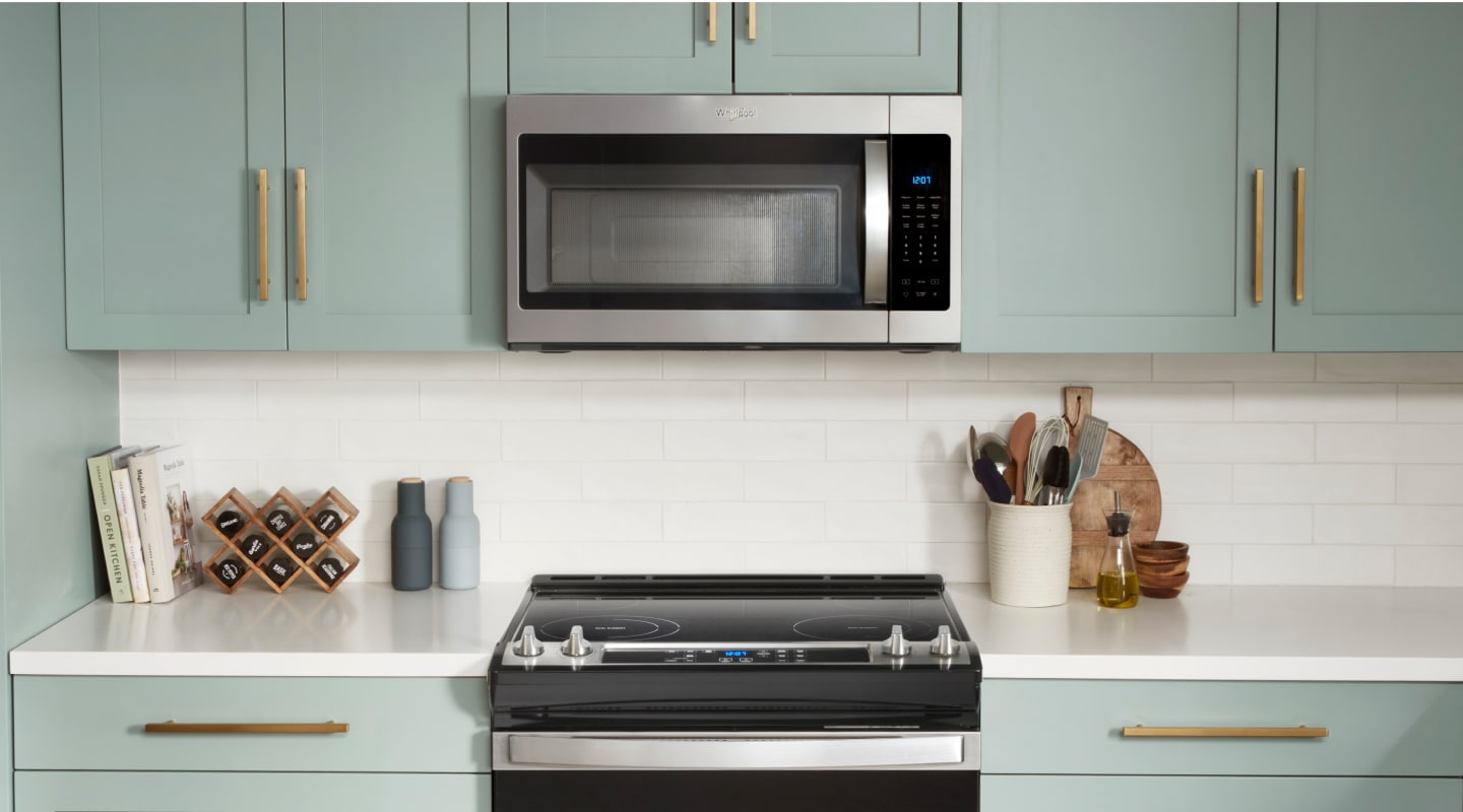 Over-the-range microwave above electric stove in light blue cabinetry Over-the-range microwave above electric stove in light blue cabinetry