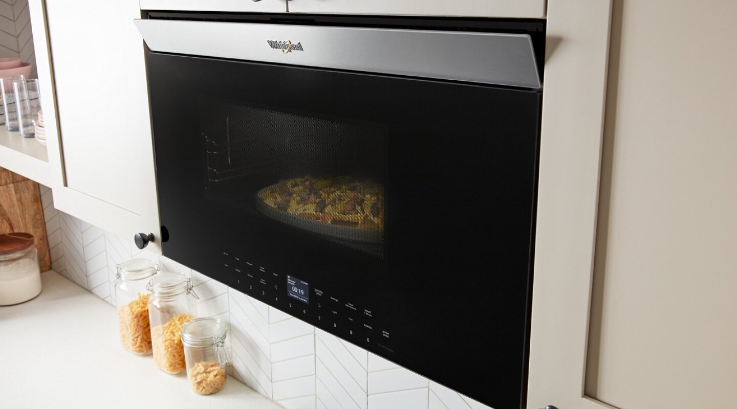 Nachos cooking inside a Whirlpool® Over-the-Range Microwave Nachos cooking inside a Whirlpool® Over-the-Range Microwave