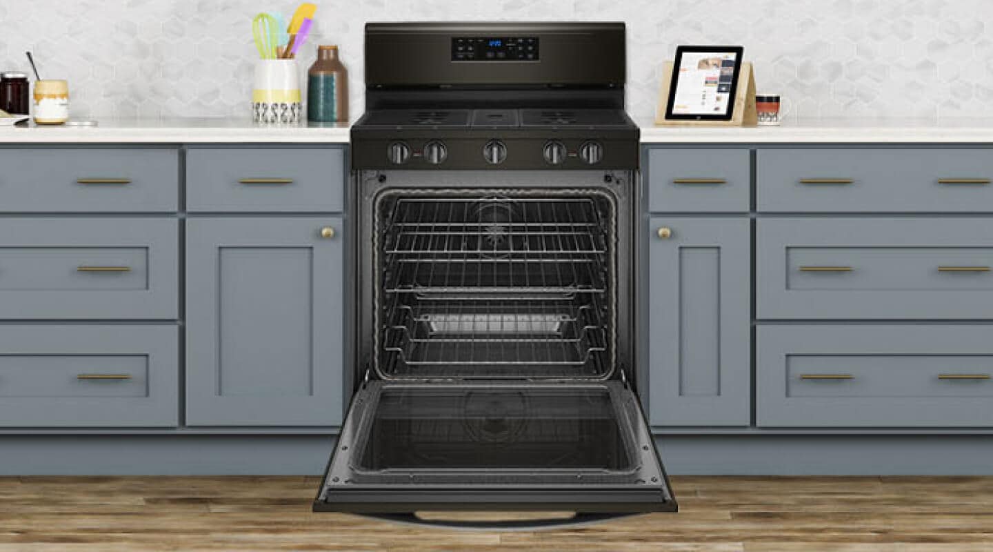 An open oven with multiple oven racks An open oven with multiple oven racks