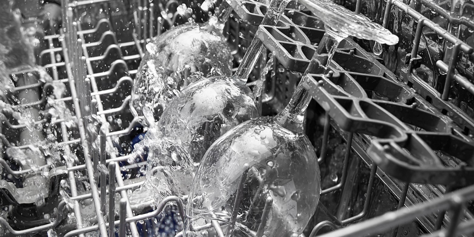 Close-up of wine glasses in dishwasher during wash cycle Close-up of wine glasses in dishwasher during wash cycle