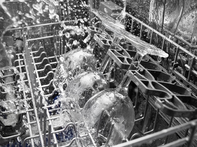 Close-up of wine glasses in dishwasher during wash cycle Close-up of wine glasses in dishwasher during wash cycle