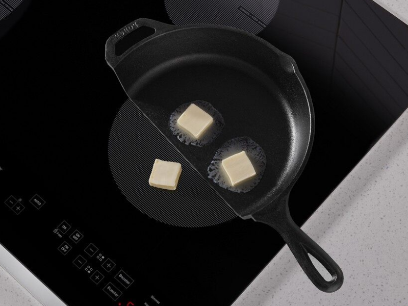 Butter in a cast iron pan melting on a Whirlpool® induction cooktop Butter in a cast iron pan melting on a Whirlpool® induction cooktop