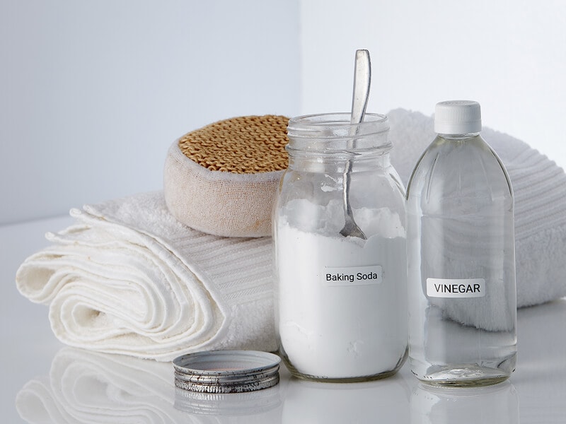  Baking soda and vinegar next to a towel