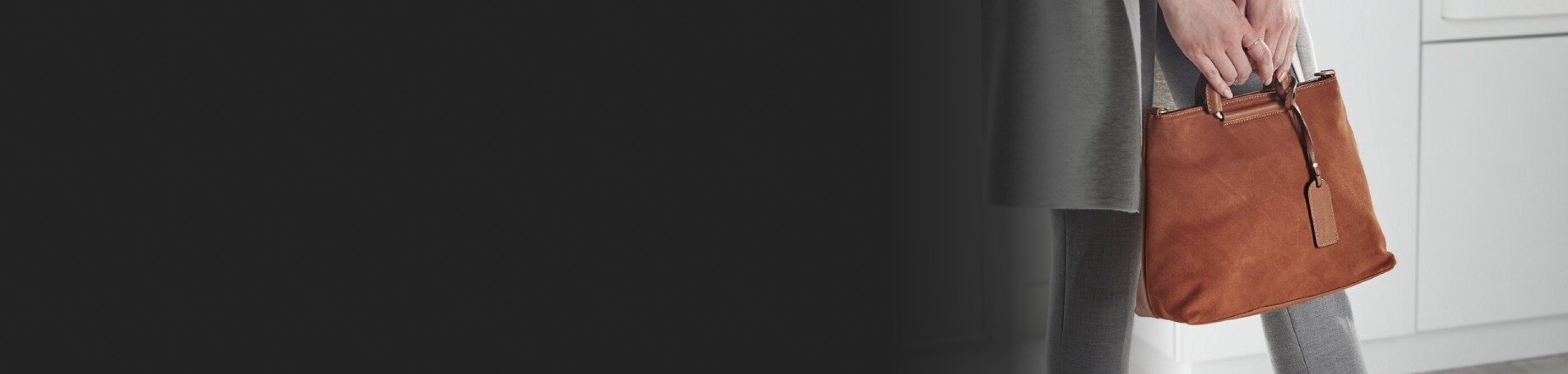 Person holding a suede handbag