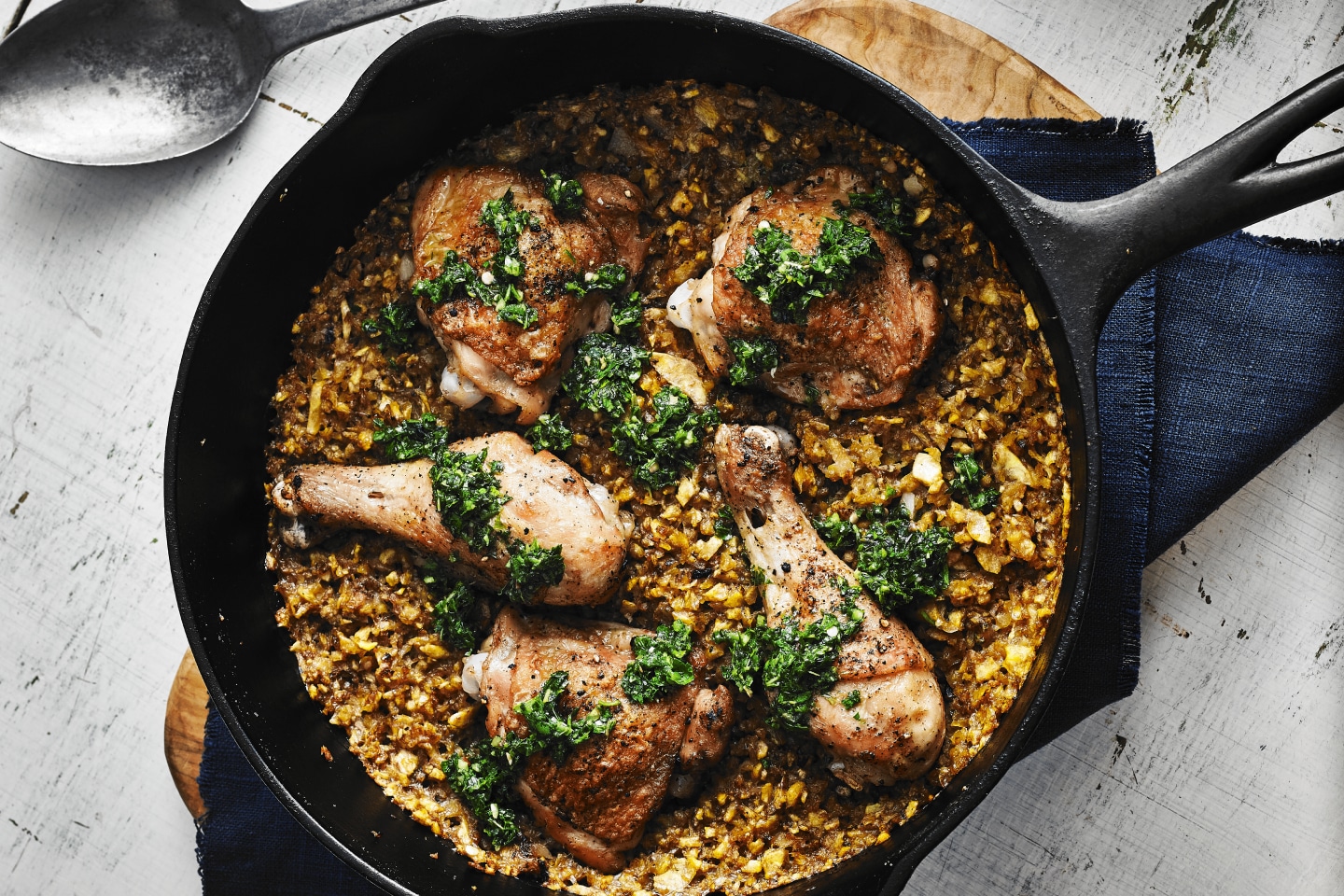 Cast iron skillet filled with baked chicken and rice medley Cast iron skillet filled with baked chicken and rice medley