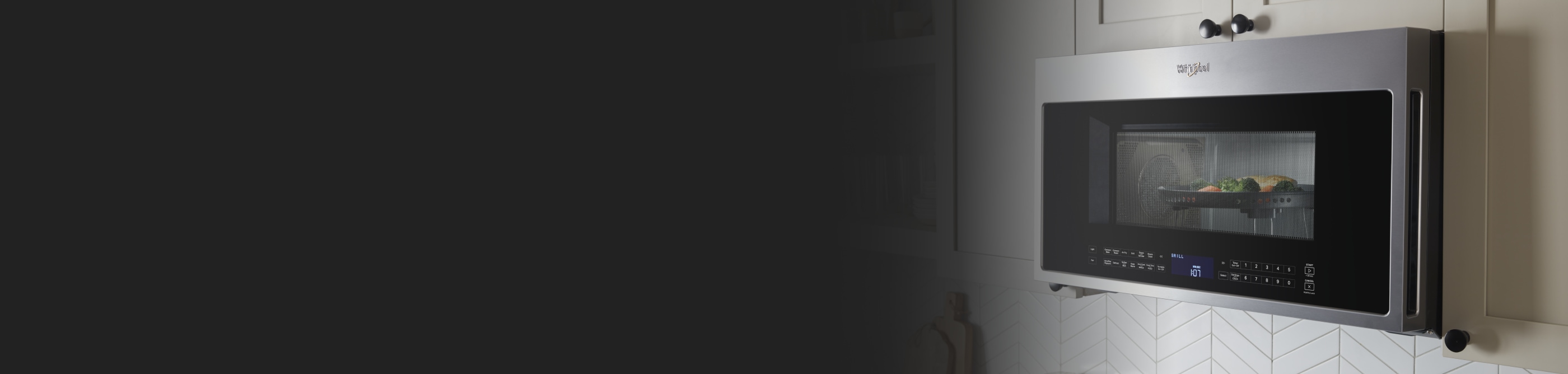 Over-the-range, Whirlpool® stainless steel microwave with chicken and vegetables inside