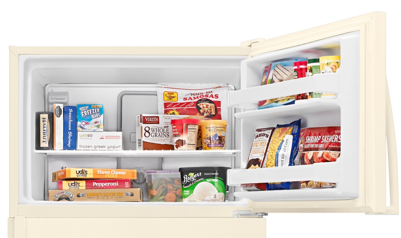 Top mount freezer with a variety of frozen food inside Top mount freezer with a variety of frozen food inside