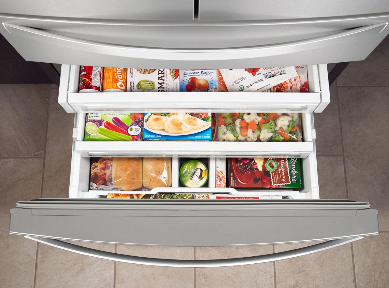 Bottom mount freezer with shelves holding frozen food
