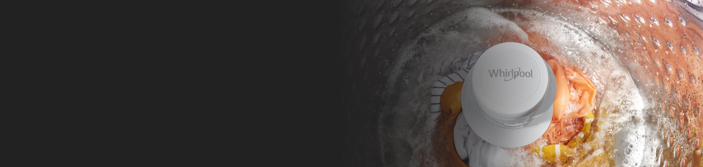 Orange fabric agitating in a Whirlpool® Top Load Washer full of water