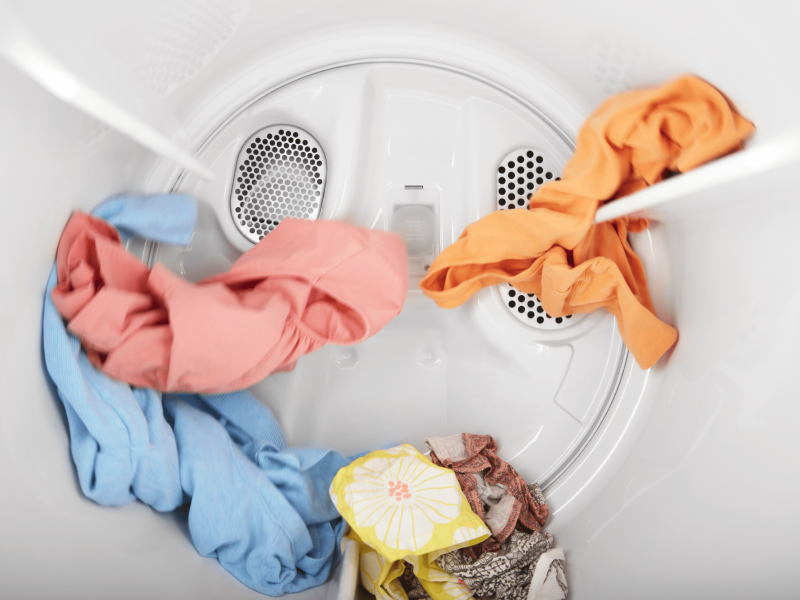 A small load of laundry tumbling in a dryer. A small load of laundry tumbling in a dryer.