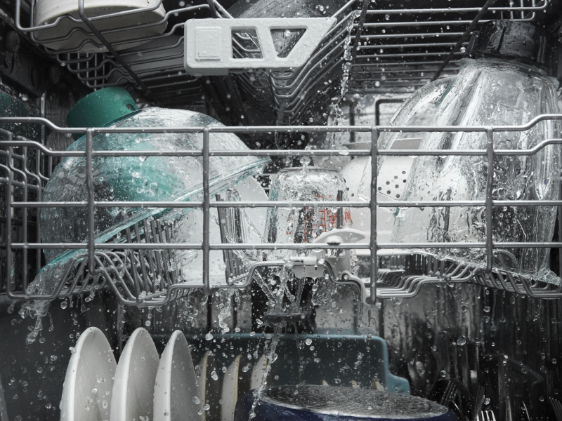 Dishes in the middle of a dishwasher cycle Dishes in the middle of a dishwasher cycle