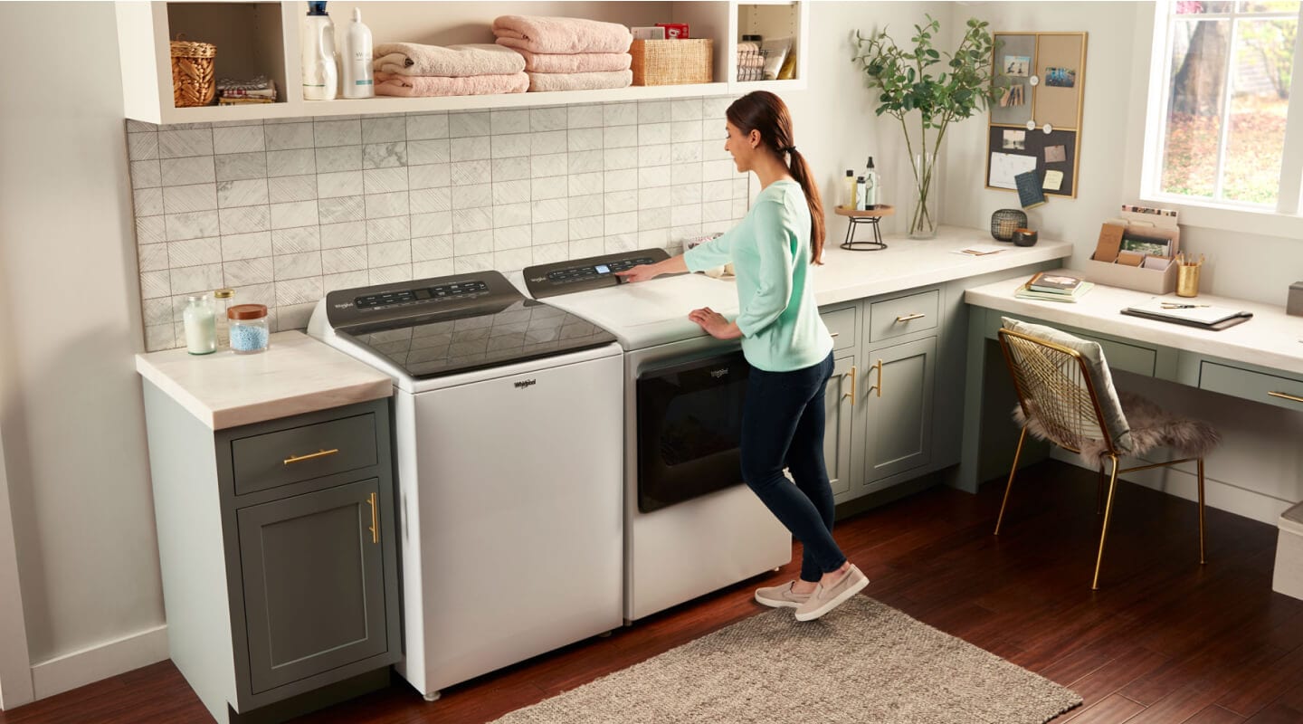A woman making a cycle selection on a Whirlpool® dryer A woman making a cycle selection on a Whirlpool® dryer