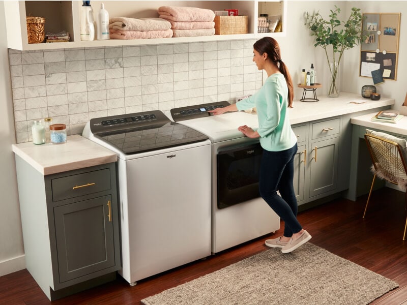 A woman making a cycle selection on a Whirlpool® dryer A woman making a cycle selection on a Whirlpool® dryer