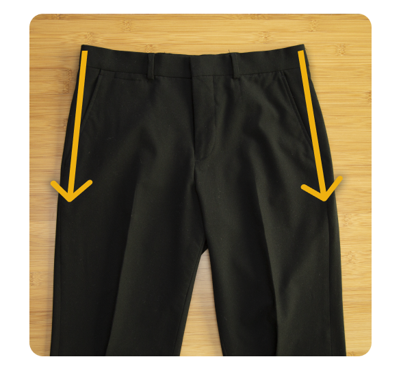 Creased pants laying flat on a table Creased pants laying flat on a table