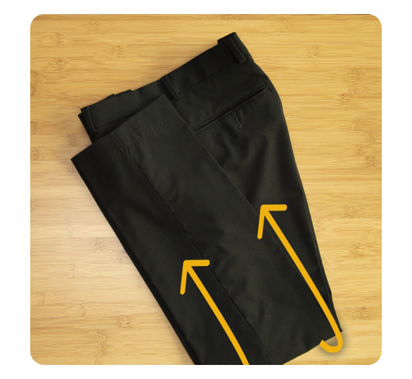 Pants folded in half with arrows facing up Pants folded in half with arrows facing up