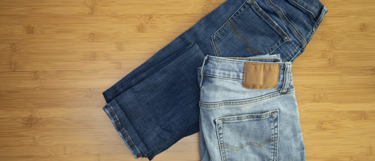 Two pairs of jeans on a table Two pairs of jeans on a table