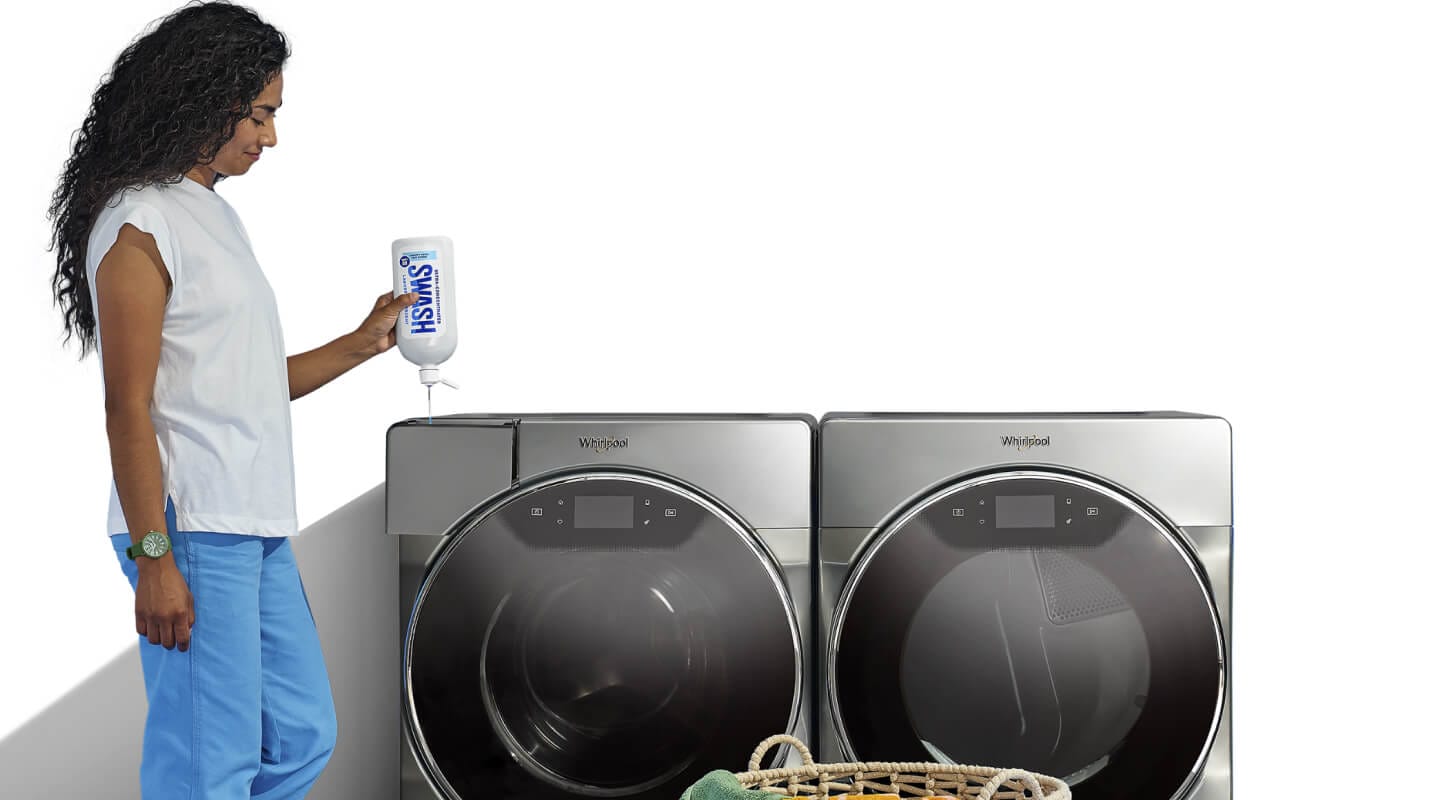 Woman adding Swash® detergent in a front load washing machine Woman adding Swash® detergent in a front load washing machine