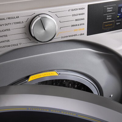 A knob pointing to different cycle settings on a front load washer