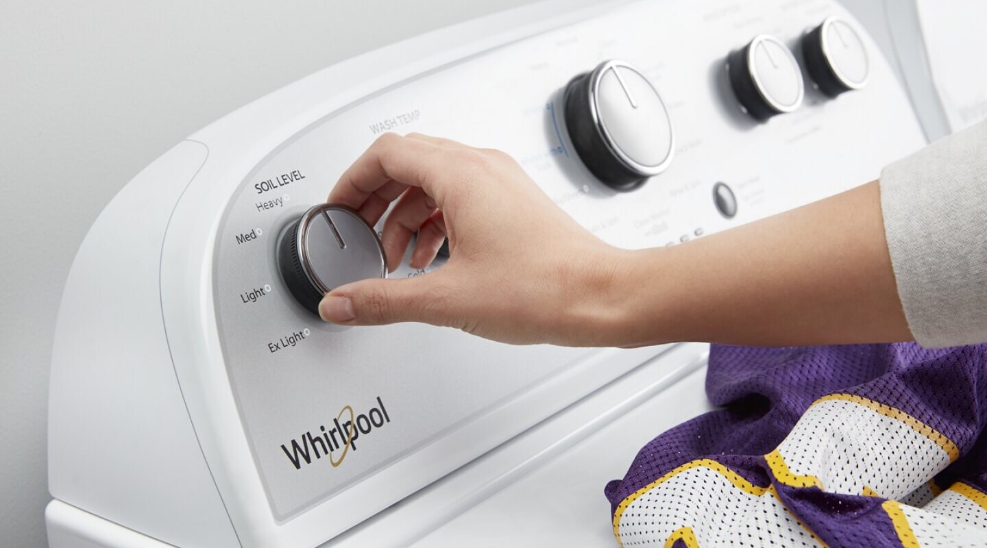 Person selecting a setting on a Whirlpool® Washing Machine Person selecting a setting on a Whirlpool® Washing Machine