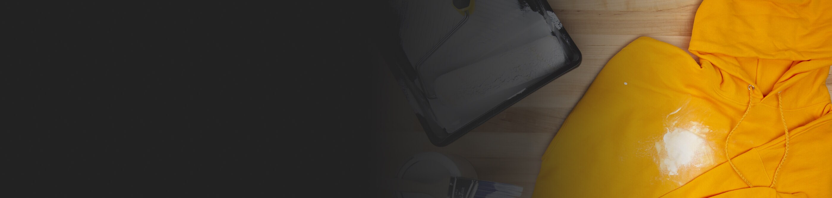 A white paint stain on a yellow sweatshirt