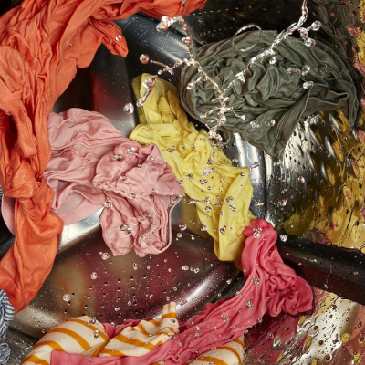 Wet clothes being washed in washer 