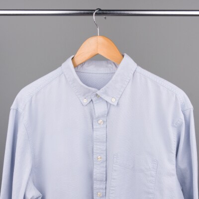 A button up shirt drying on a hanger