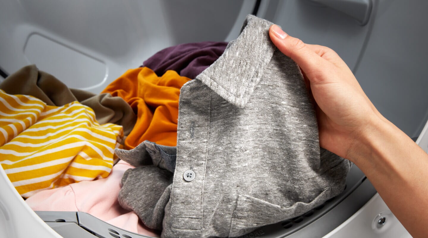 Person holding gray collared shirt