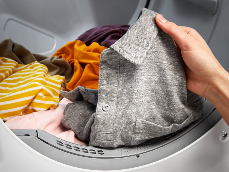 Person holding gray collared shirt