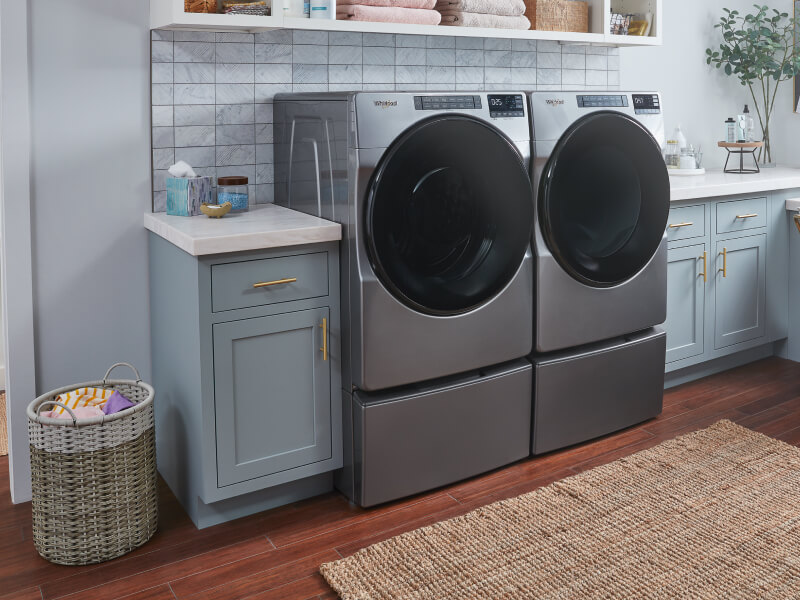 Whirlpool® Front Load Washer and Dryer in a laundry room Whirlpool® Front Load Washer and Dryer in a laundry room