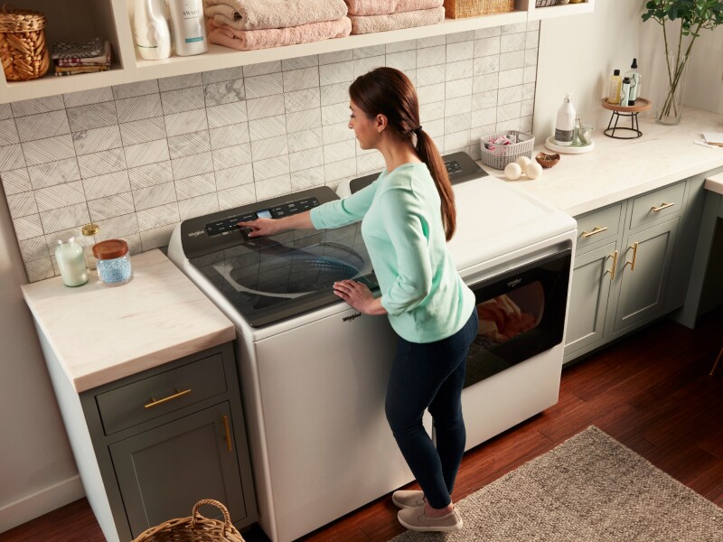 Person changing washer settings Person changing washer settings