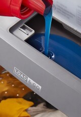 Detergent pouring into a Load & Go™ Dispenser