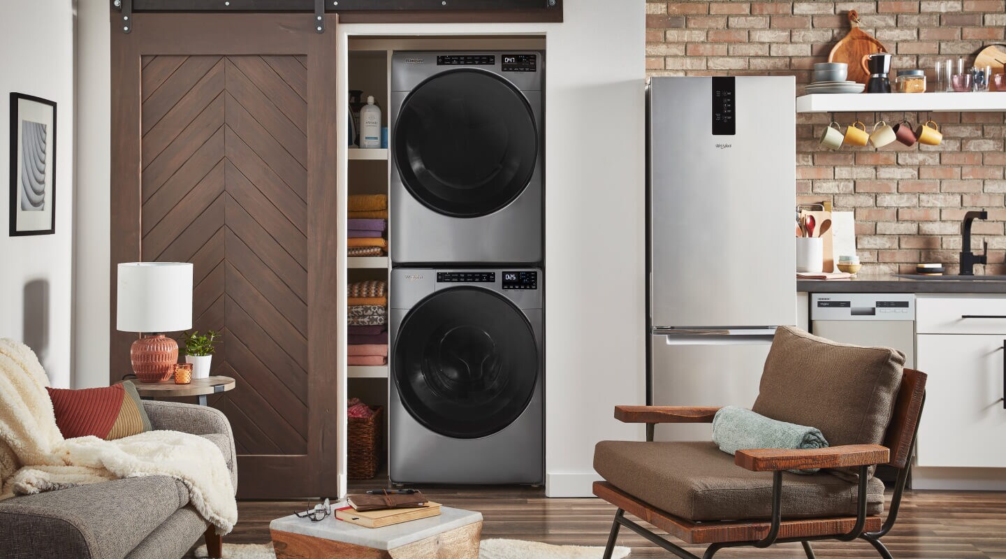 A stacked Whirlpool® Washer and Dryer in a laundry closet