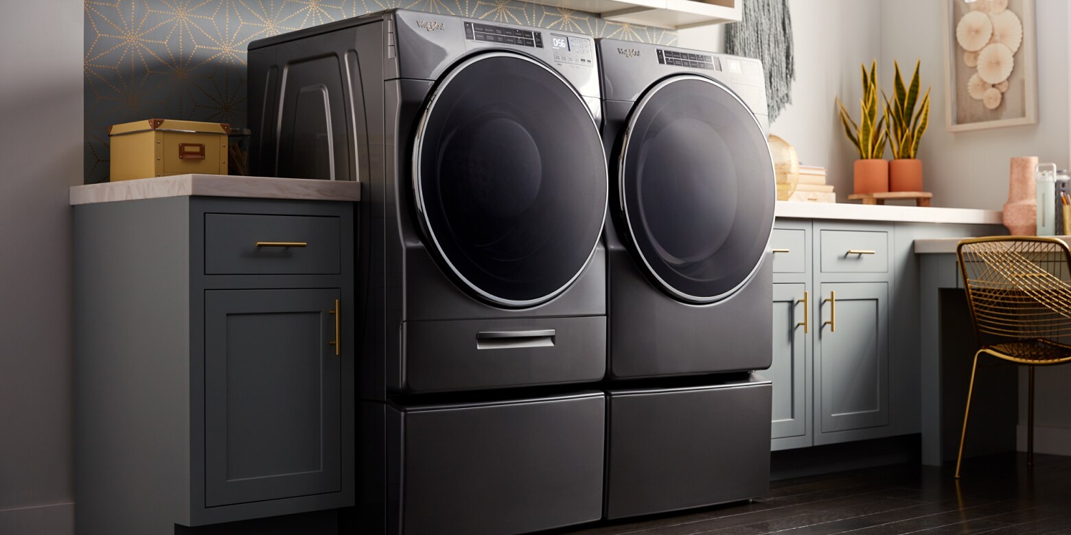 A black Whirlpool® washer and dryer pair in a laundry room