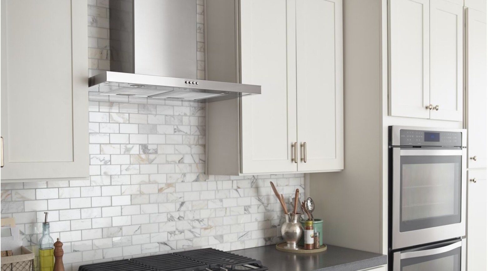 White kitchen with view of cabinets and range hood
