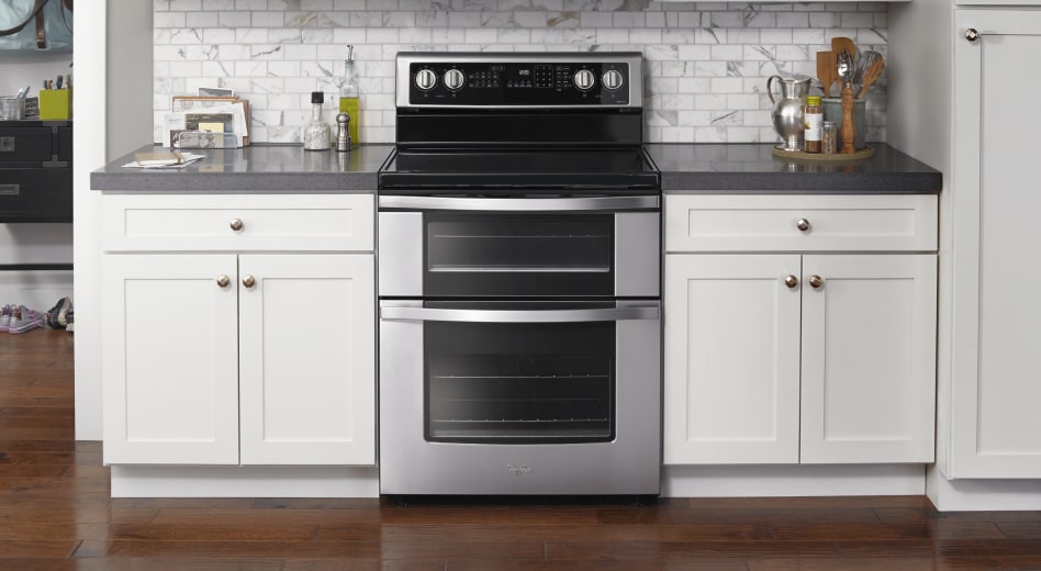 Stainless steel double oven installed between white cabinetry Stainless steel double oven installed between white cabinetry