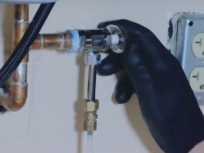 A person turning off a water valve