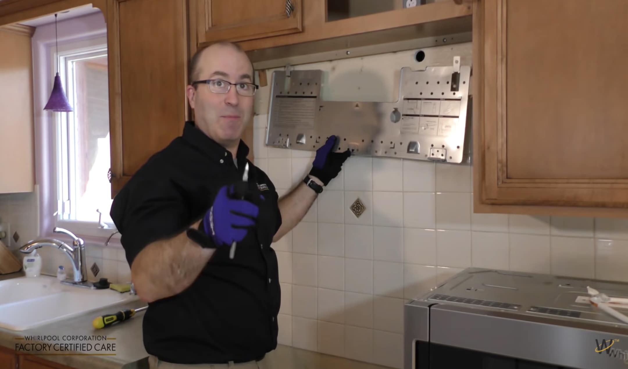 Person holding mounting bracket against wall