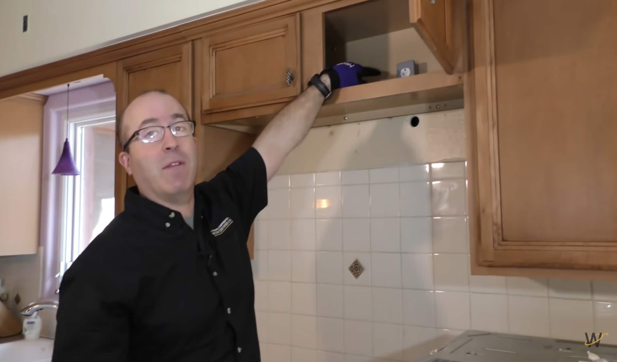 Person standing next to cleared work area for microwave installation
