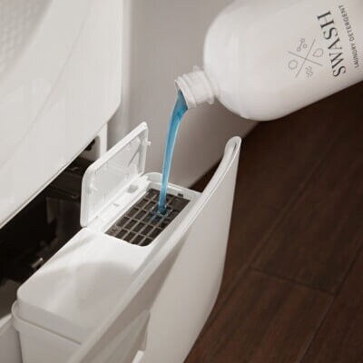 Swash® Laundry Detergent being added to washer