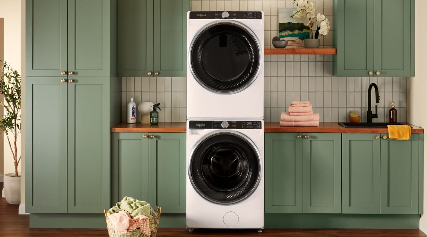 A stacked Whirlpool® Washer and Dryer set in a laundry room