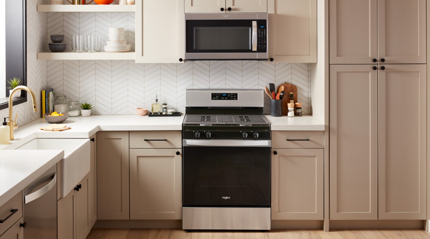 A slide-in range and over-the-range microwave in a modern kitchen A slide-in range and over-the-range microwave in a modern kitchen