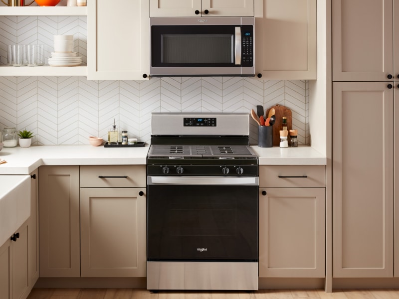 A slide-in range and over-the-range microwave in a modern kitchen A slide-in range and over-the-range microwave in a modern kitchen